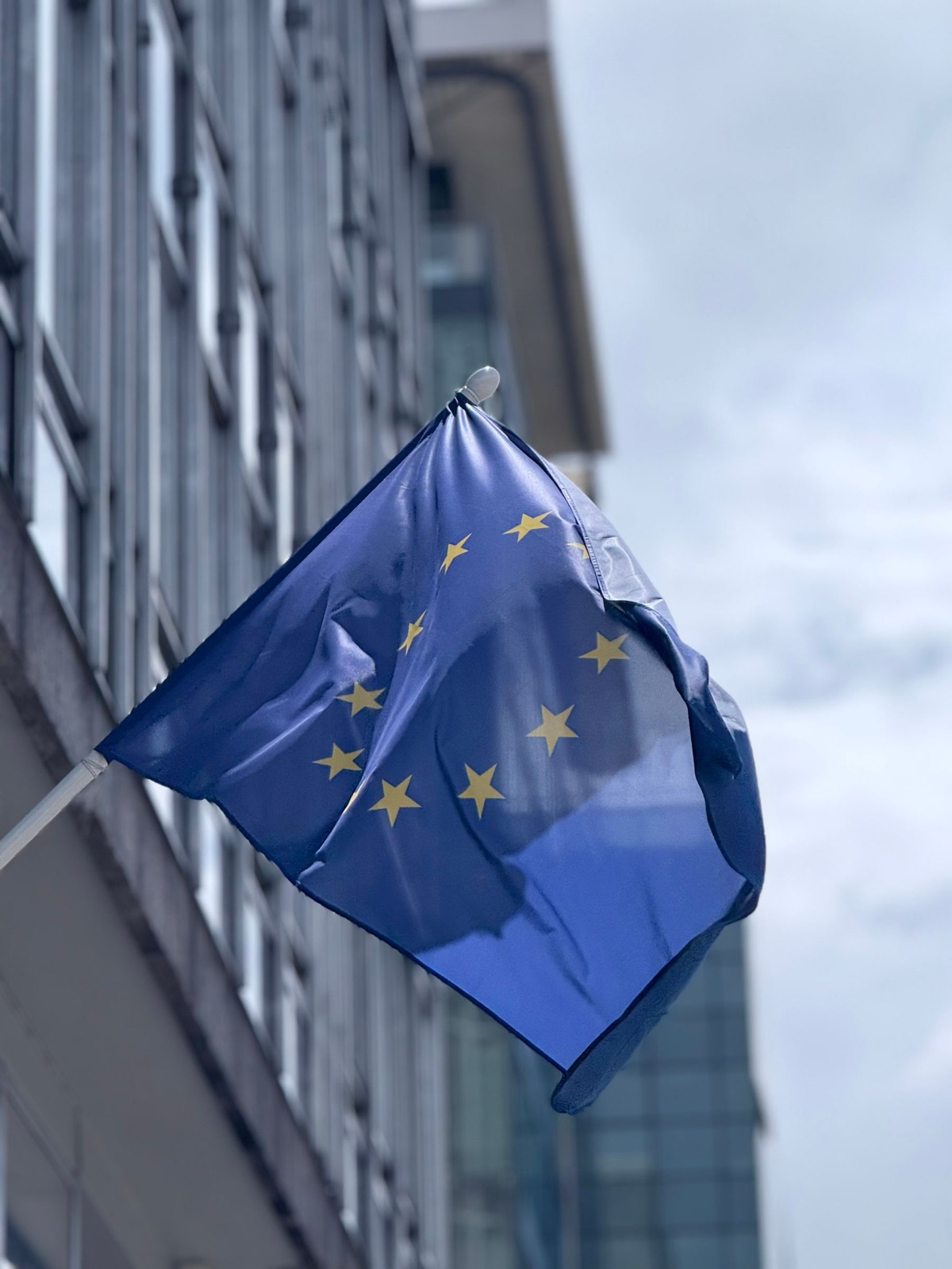 EU flag waving at a modern building